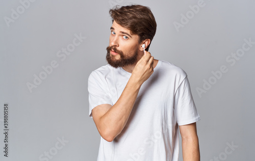 handsome guy in headphones on gray background white t-shirt emotions model