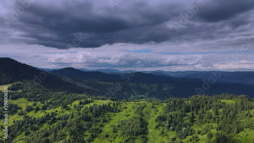 Fototapeta Naklejka Na Ścianę i Meble -  Green hills with scattered trees at the base of Mount Ceahlau - Romania
