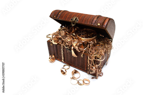 Treasure chest full of gold jewelry. Old used gold jewelry in a wooden box on white background.