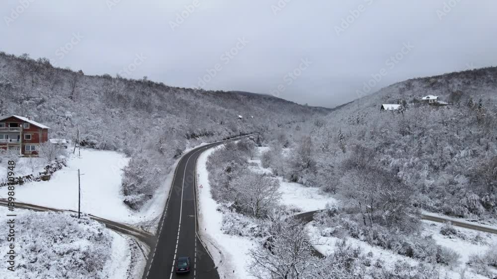 High angle aerial view drone image on the road trough the trees and forest in mountain range covered with white snow in winter day near Knjazevac in Serbia - Travel journey and vacation concept High angle aerial view drone image on the road trough the trees and forest in mountain range covered with white snow in winter day near Knjazevac in Serbia - Travel journey and vacation concept