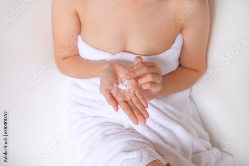 Woman applying cream,lotion on hand with white background, Beauty concept, Top view.