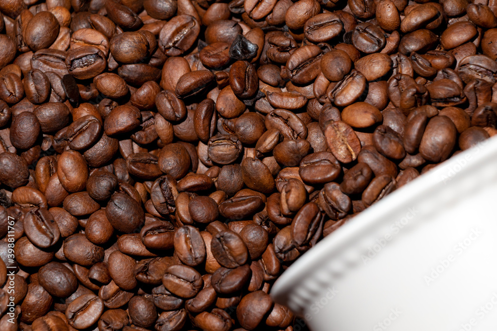 Fototapeta premium Coffee grains and partial cup background