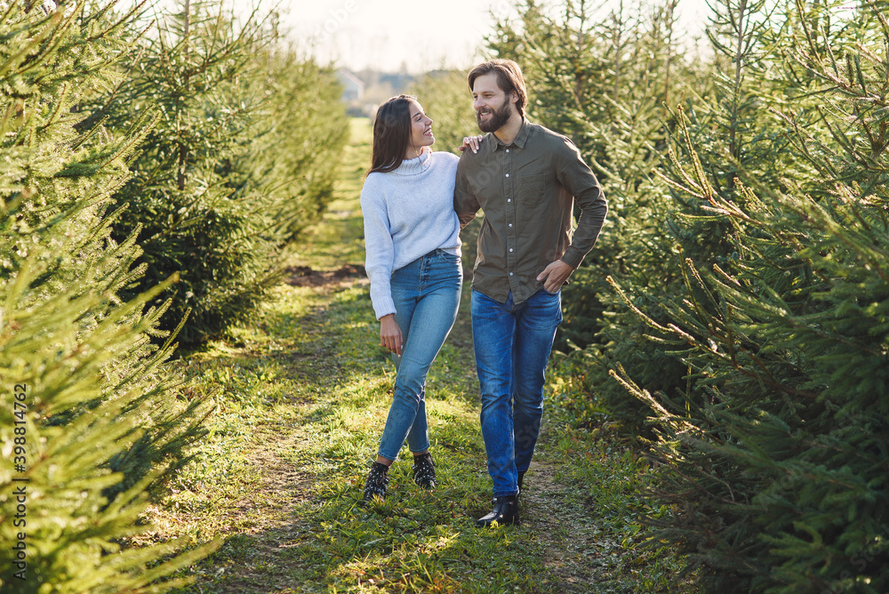 Young happy family choosing christmas tree at plantation preparing holidays. Young happy family choosing christmas tree at plantation preparing holidays.