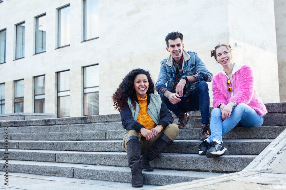 Fototapeta premium cute group of teenages at the building of university with books huggings, diversity nations real students lifestyle