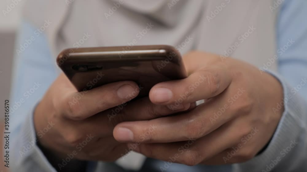 Close up of woman holding and using smart mobile phone, scrolling browsing internet on gadget Close up of woman holding and using smart mobile phone, scrolling browsing internet on gadget
