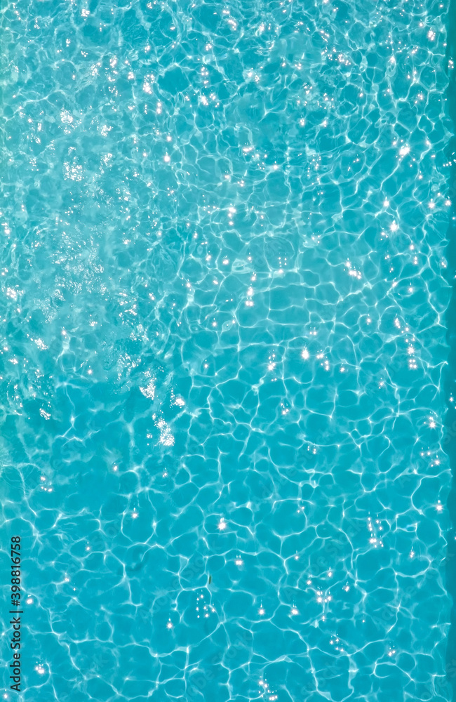 Aerial view of a large crystal blue pool. A lot of negative space is in the image
