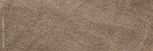 fabric grunge background  real cotton denim brown  wrinkled  frayed  close