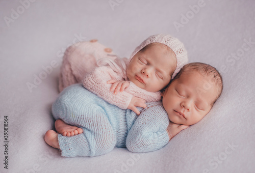 Twins are newborn brother and sister. Newborn girl and boy. Sleep sweetly and smile