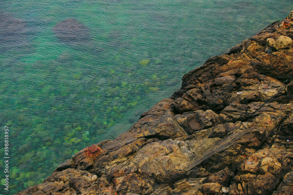 Top view of a geometric photo between sea water and rocks 