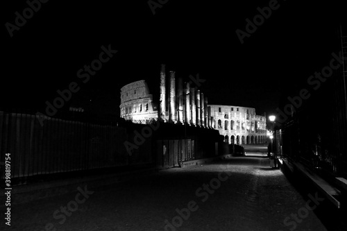 The monuments of rome in black and white at night. 