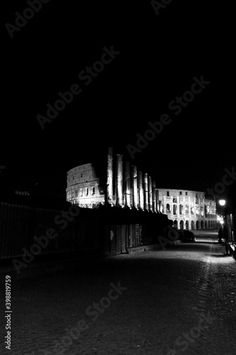 The monuments of rome in black and white at night. 