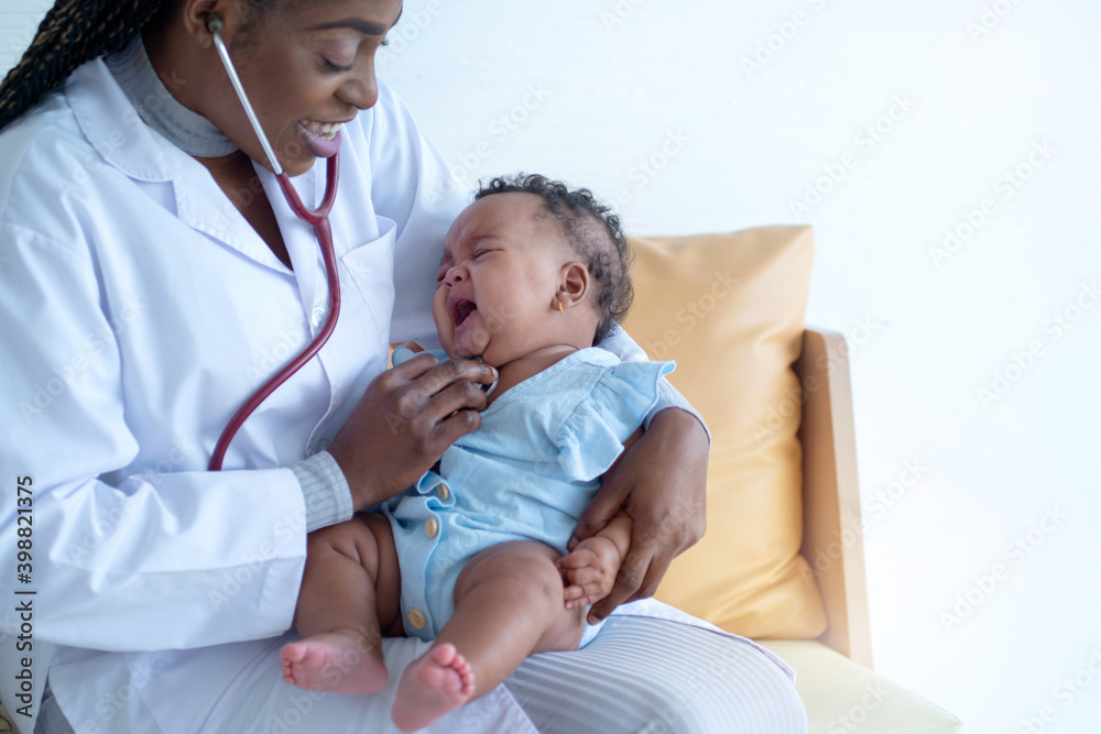 African doctor checking mix race newborn baby, Pediatrician examining baby girl with stethoscope African doctor checking mix race newborn baby, Pediatrician examining baby girl with stethoscope