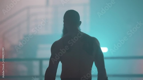 Boxer in the boxing gym. Bandages his hands. Sparring in the ring. Boxer jumping rope. Exercise with ropes. Round one. Fog in the ring. Zetsky sport. Beautiful backlight. World boxing champion.

 photo