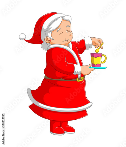 The grandmother using the red costume standing and making a cup of tea