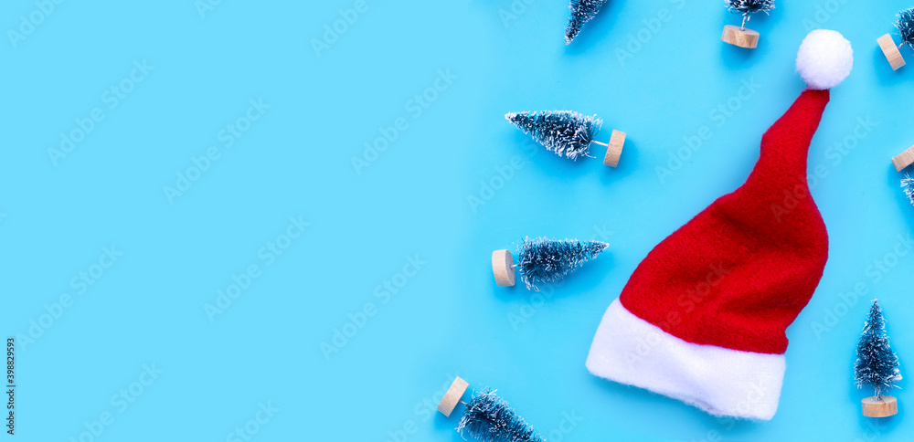 Santa hat with miniature christmas pine tree on blue background. Santa hat with miniature christmas pine tree on blue background.