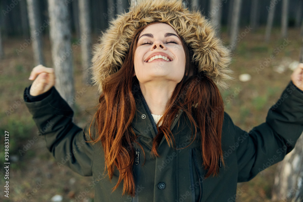 Woman with closed eyes in hooded jacket looks upstairs fresh air Freedom lifestyle Woman with closed eyes in hooded jacket looks upstairs fresh air Freedom lifestyle