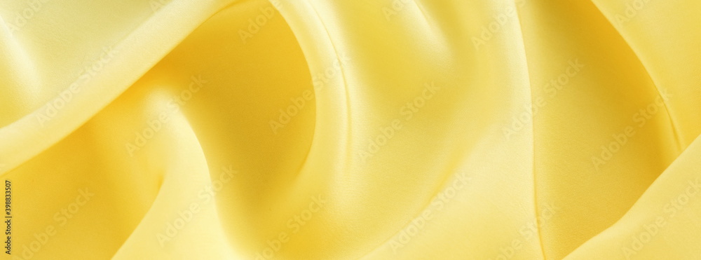Obraz premium silk fabric texture yellow color . copy space.Fabric background.