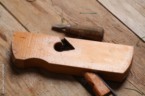 carpenter's tools lie on a wooden table clamp plane