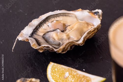  Raw Oyster and Stout with a Lemon Wedge, an Irish Cuisine Speciality