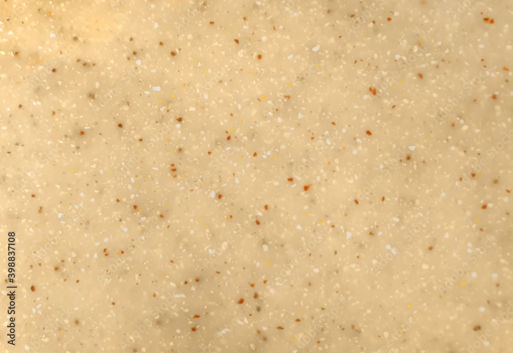 close up of light yellow solid acrylic surface stone background with white and red grains texture. interior stone material background.