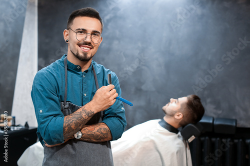 Professional hairdresser and his client in barbershop
