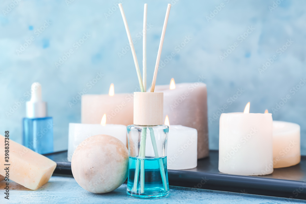 Reed air freshener and candles on color background Reed air freshener and candles on color background