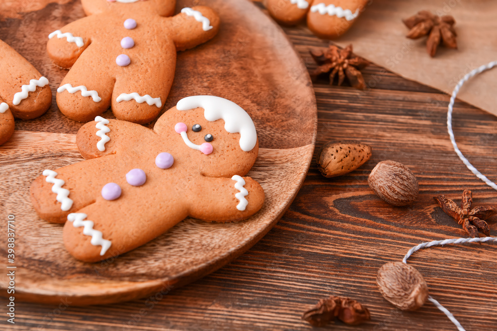 Plate with tasty gingerbread cookies on table Plate with tasty gingerbread cookies on table