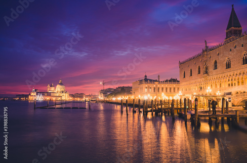 Riva degli Schiavoni boulevard near Santa Maria della Salute cathedral at dusk in Venice, Italy 