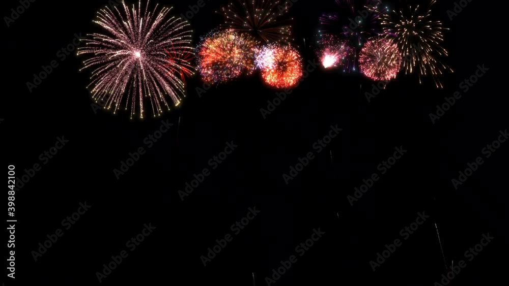 Happy New Year 2021 greeting text with colorful fireworks and sparks on black night sky.