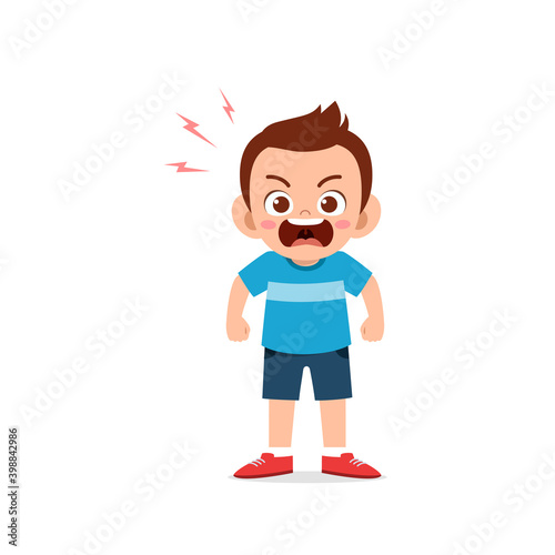 cute little kid boy stand and show angry pose expression