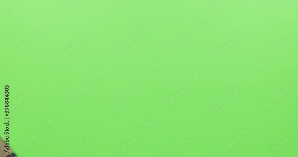 A black clapper board used on green screen, a man hand with movie production clapper board A black clapper board used on green screen, a man hand with movie production clapper board