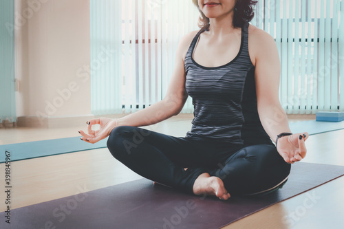 Woman yoga practice exercise s, sporty female practicing yoga lesson at indoor studio, doing Hero pose, relaxing, breathing, and meditating, work out and exercise for taking care of her body