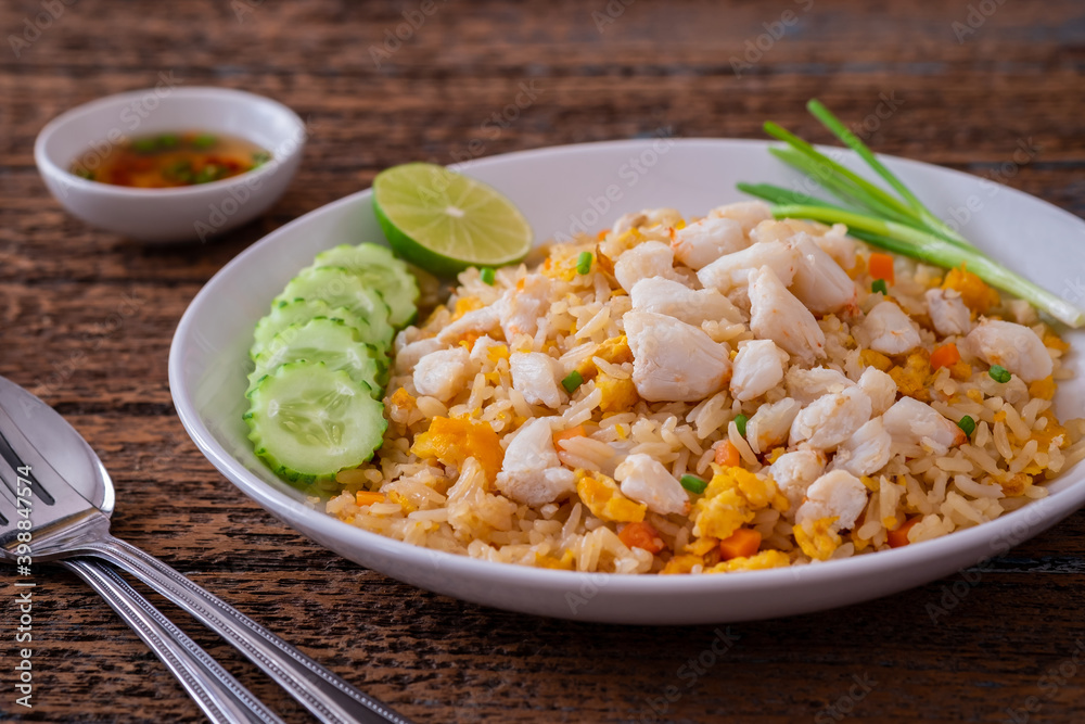 Fried rice with crab on white plate and chili fish sauce in bowl Fried rice with crab on white plate and chili fish sauce in bowl