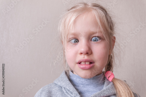little blonde girl making faces