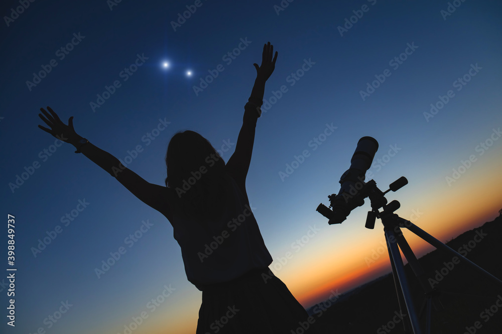 Woman looking at night sky with amateur astronomical telescope. Woman looking at night sky with amateur astronomical telescope.