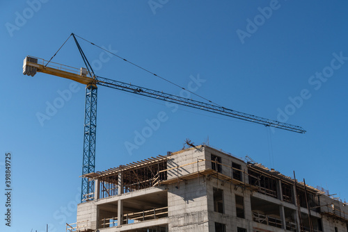 Construction of a building with a remotely controlled unmanned crane