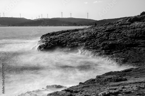 Long exposure black and white image of Urla, Altinkoy bay. A boy looked like a ghost. photo