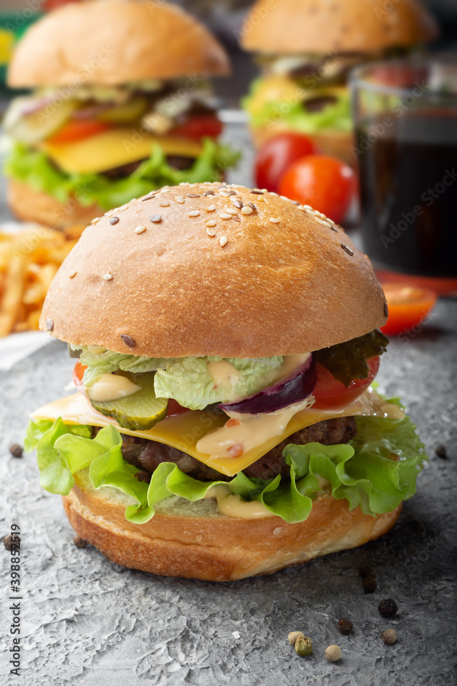 Burgers with a drink. Vertical photo of burgers. Three burgers with a drink. Burgers with a drink. Vertical photo of burgers. Three burgers with a drink.