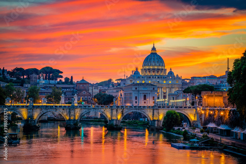 Sunset view of old Sant' Angelo Bridge and St. Peter's cathedral in Vatican City, Rome.Italy
