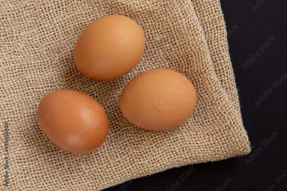 Fresh chicken eggs on burlap sack, top view. Fresh chicken eggs on burlap sack, top view.