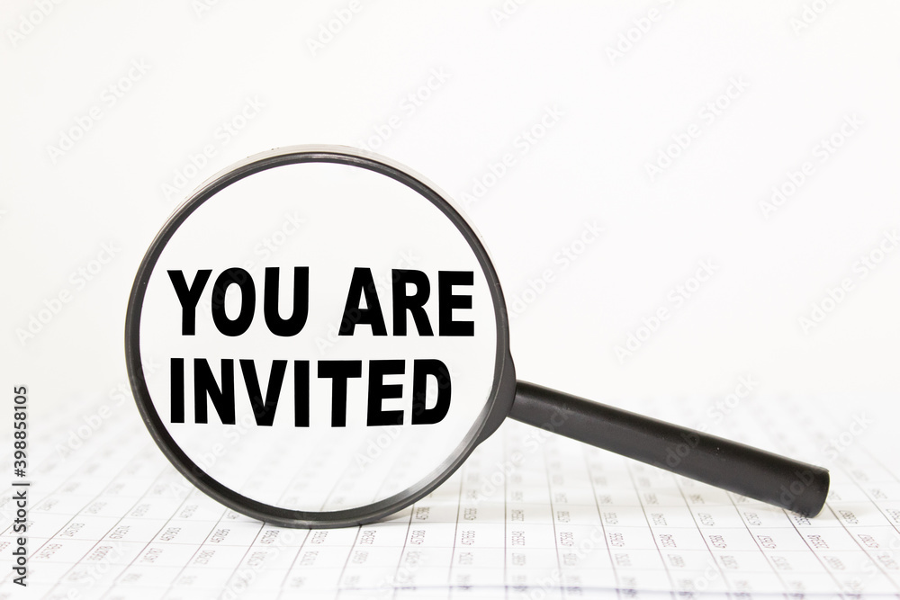 words YOU ARE INVITED in a magnifying glass on a white background. business concept words YOU ARE INVITED in a magnifying glass on a white background. business concept