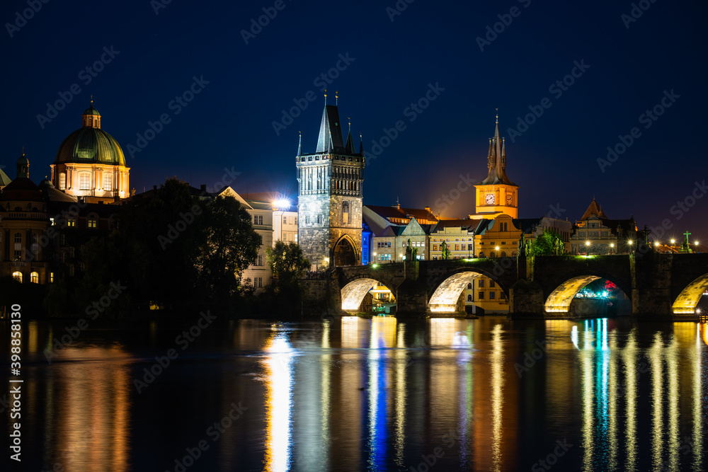 Charles bridge and old tower at night in Prague, Czech Republic