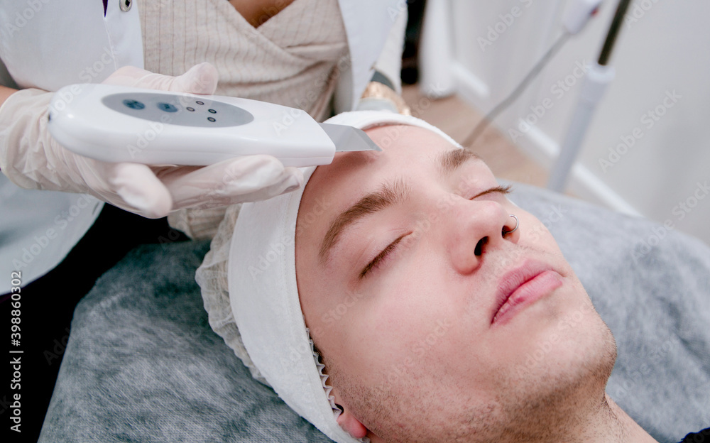 man undergoing a procedure in a beautician man undergoing a procedure in a beautician