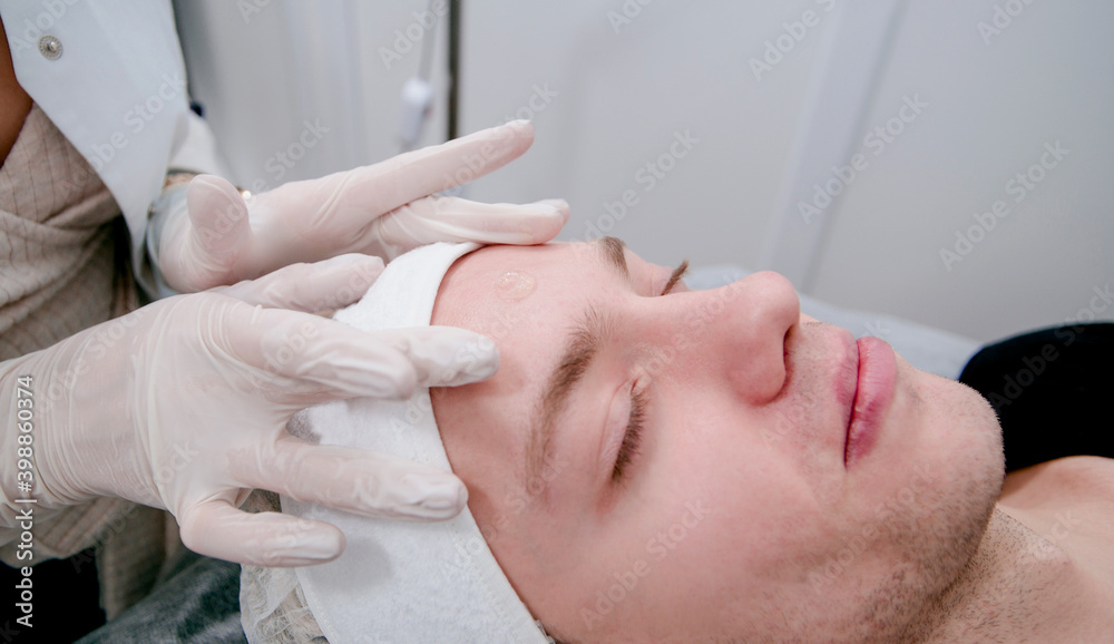 man undergoing a procedure in a beautician man undergoing a procedure in a beautician