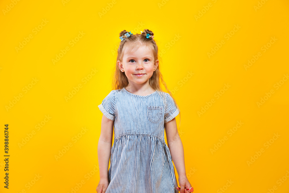 Happy caucasian child girl smiling to camera over yellow background Happy caucasian child girl smiling to camera over yellow background