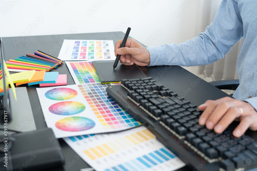 interior designer or creative graphic designer working on project architectural with colour samples with work tools and equipment for selection in office interior designer or creative graphic designer working on project architectural with colour samples with work tools and equipment for selection in office