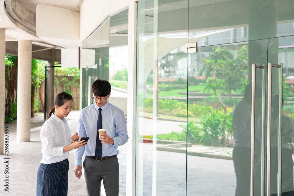 Two Business Colleagues Having Discussion new project business meeting outside office in an urban setting Two Business Colleagues Having Discussion new project business meeting outside office in an urban setting