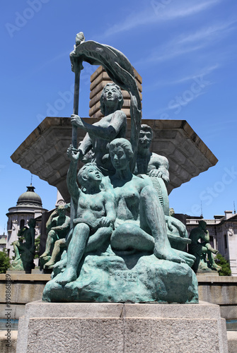 Bronze statues and water fountain in downtown Seoul, South Korea near the Shinsegae and the general post office. photo