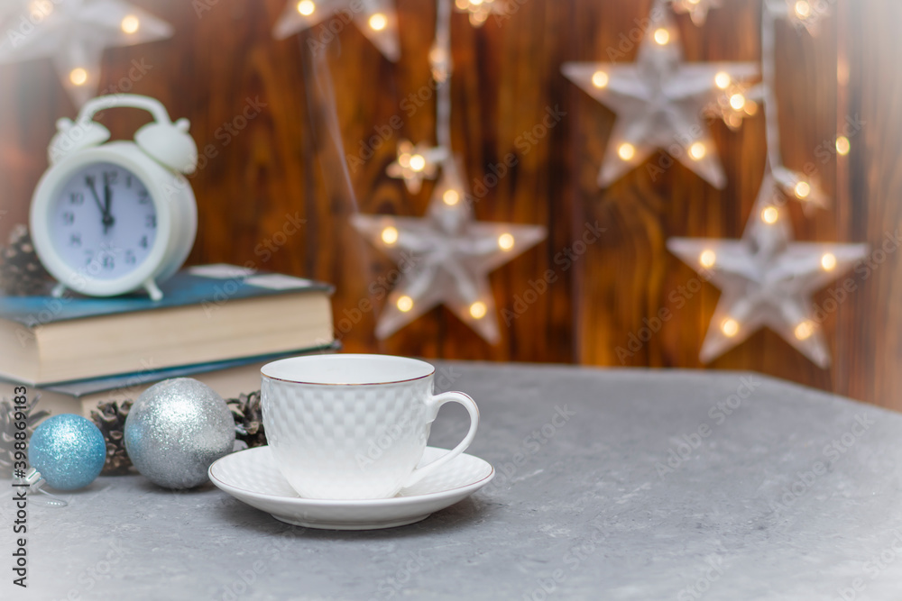 White cup and saucer in winter composition. Hot drink on table. Selective focus, fog view White cup and saucer in winter composition. Hot drink on table. Selective focus, fog view