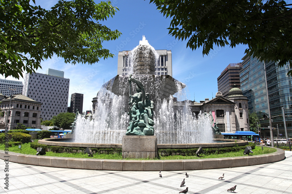 Bronze statues and water fountain in downtown Seoul, South Korea near the Shinsegae and the general post office.